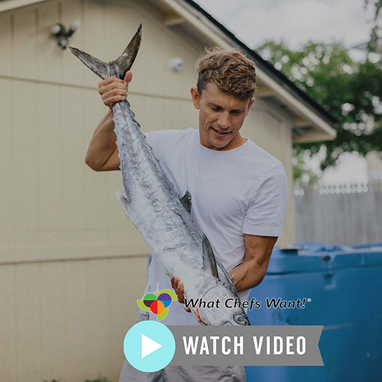 Kelly holding up giant Kingfish by the tail